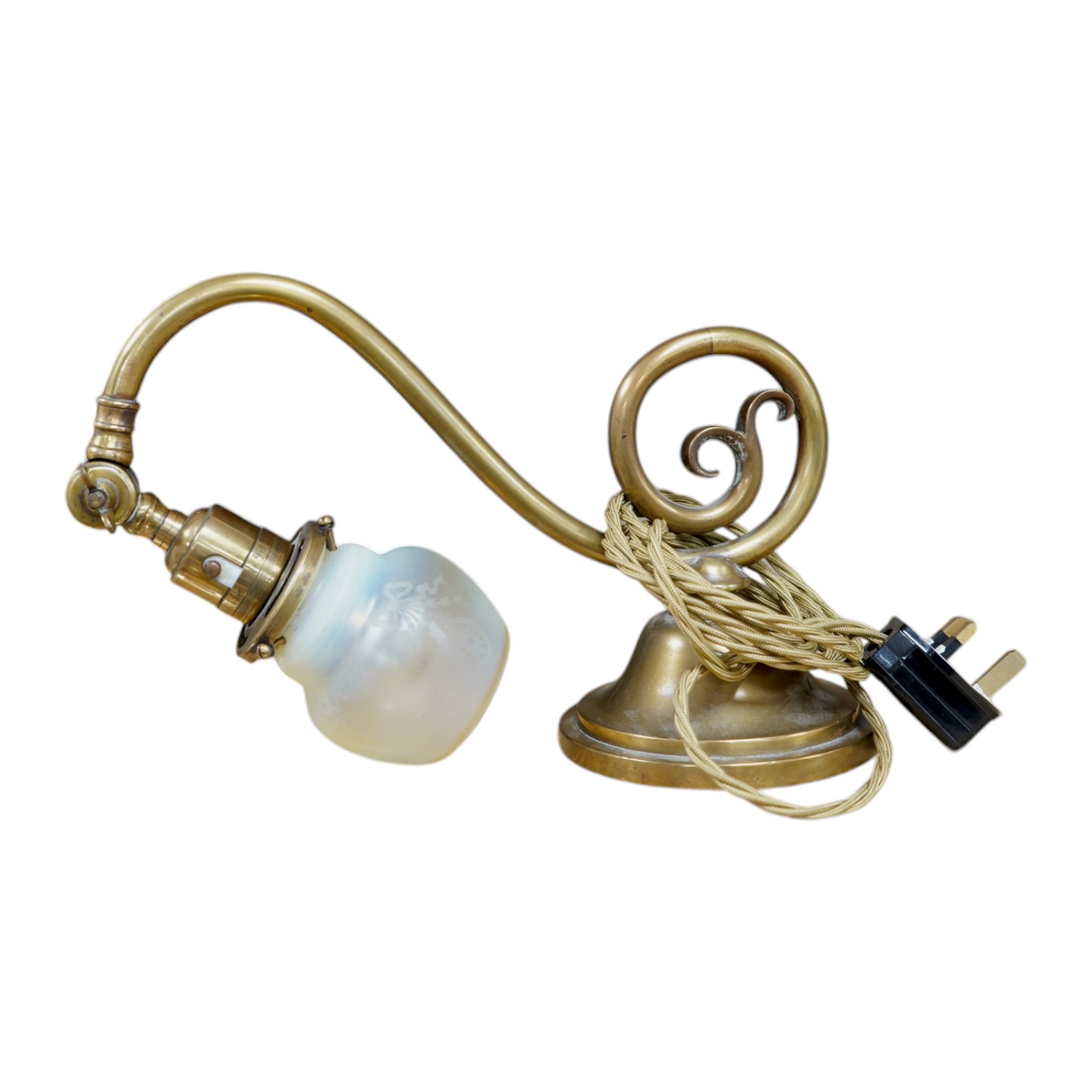 A brass piano lamp with original acid etched miniature Vaseline shade, circa early 20th century, wired, 20cm high, projection 43cm. Condition - fair to good, some minor nibbles to the shade